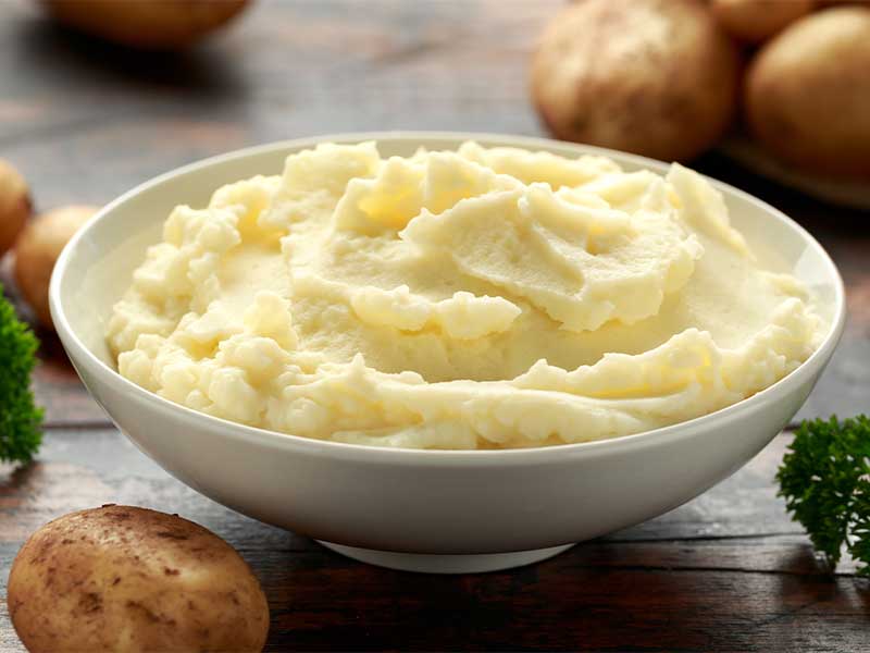 Verzichte bei Kartoffelpüree auf Butter und Sahne und greife stattdessen zu etwas pflanzlicher Milch und Kräutern.